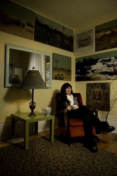 Artist Shannon Taylor relaxes in her home, surrounded by her artwork. Photographer Mike Taylor of Peterborough captured this image early in 2017.