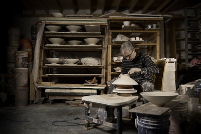 Potter Bill Reddick works the details into a new bowl.